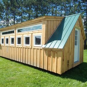 12x20 cabin with dormer with six insulated awning windows and two fixed transom windows, green metal roof, nine-lite door.