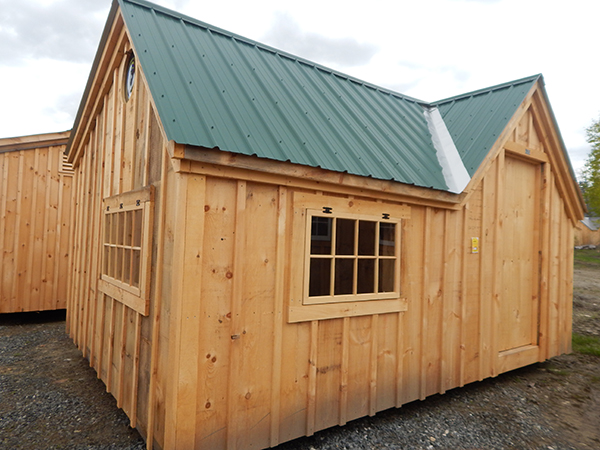 12x20 Xylia with solid pine door, single pane barn sash windows and a glass roundel.