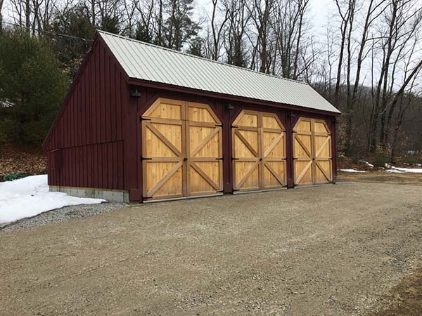 This 20x36 Equipment Shed was painted once it was built. Then the customers added custom barn doors to each bay.