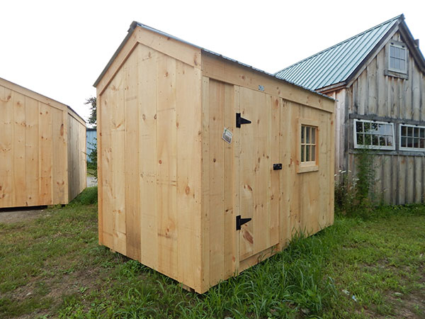 6x10 Economy Nantucket A fitted with Pine Board Siding, Rough-Sawn Pine Door, and Fixed Barn-Sash Windows.