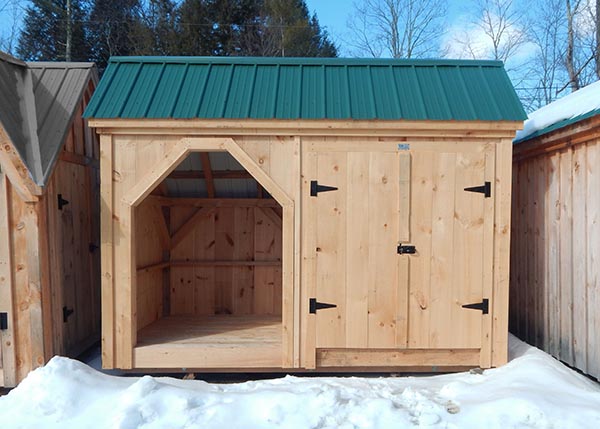 6x12 Weekender with evergreen corrugated metal roof, pine board siding and a set of solid pine double doors.