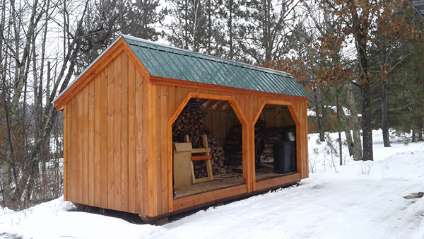 This 8x20 Woodbin was stained and topped with a green metal roof.