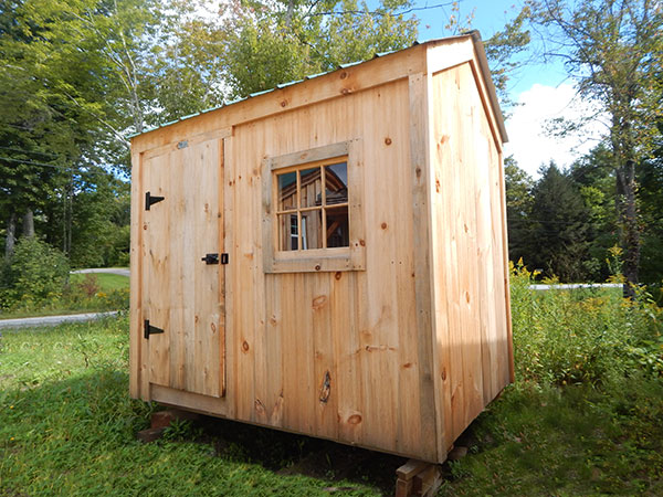 6x8 Economy Nantucket A, fitted with pine board siding and featuring a fixed barn sash window.