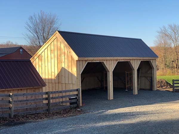 This 20x36 Equipment Shed is shown with a matte black metal roof upgrade.
