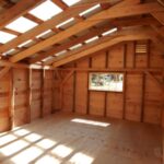 diy storage shed building kit with three sliding barn doors.