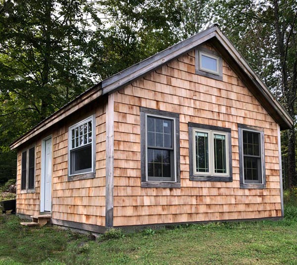 16x24 Vermont Cottage B custom built with red cedar shingled siding and a custom window and door layout.
