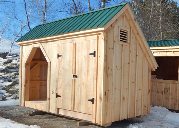 Our Weekender with pine double doors, wood louvered shed vent, green metal roof and knotty pine siding.