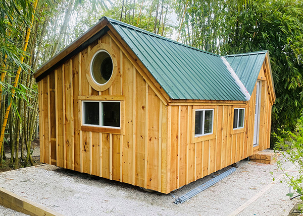 12x20 Xylia with board and batten siding and an evergreen corrugated metal roof.