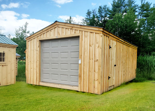 Our post and beam barn garage includes a single side door and an overhead garage door.