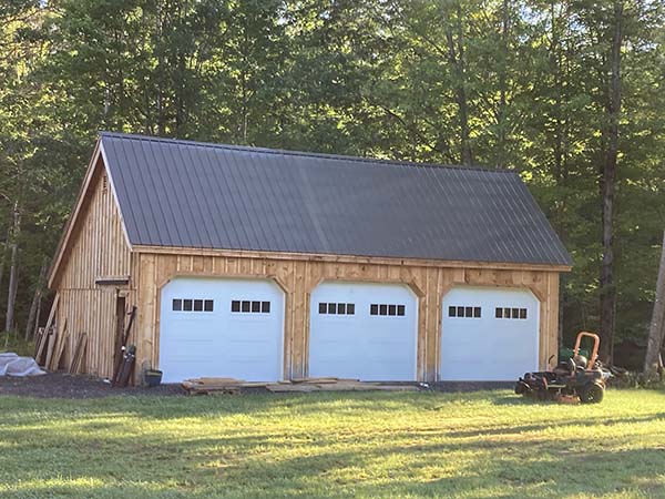 Once this Equipment Shed was built, the client installed their own overhead garage doors. This one has the charcoal gray metal roof upgrade.