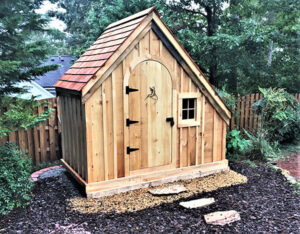 A hardware shed with cedar shingle roofing and stepping stones going to the door