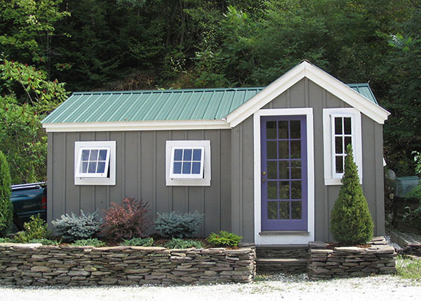 8x18 Heritage shed that has been painted gray with a custom 15-lite purple wood door and extra windows