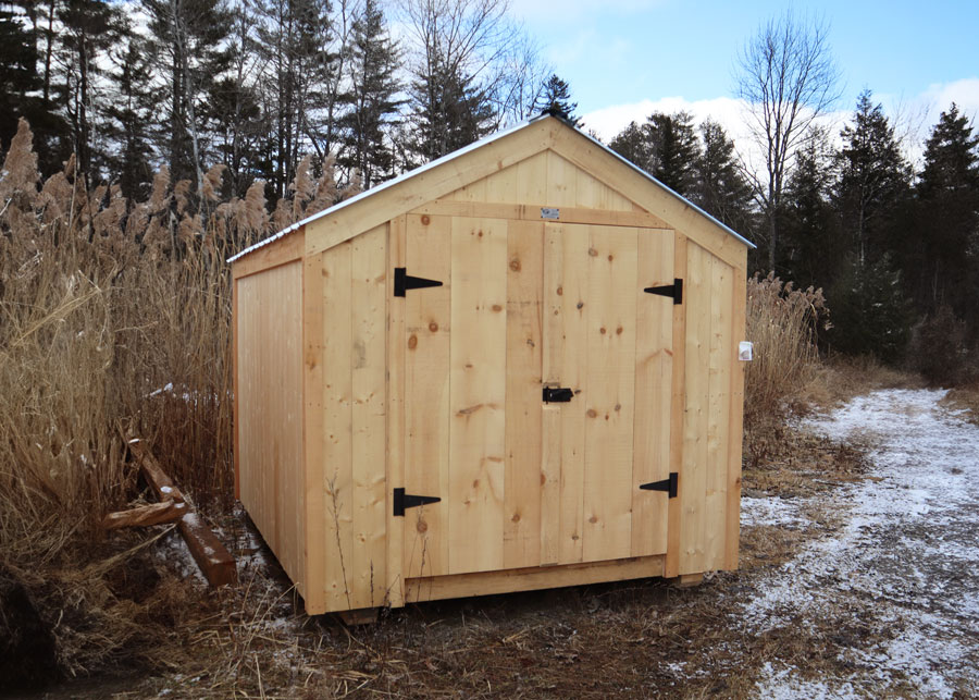 Eight foot by ten foot wooden storage shed with double doors and a metal roof.