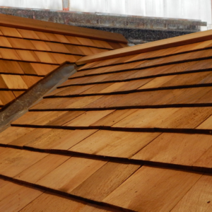 Roof valley of tiny house cottage or cabin made of 3/4"-thick Western red cedar shingles and copper flashing.