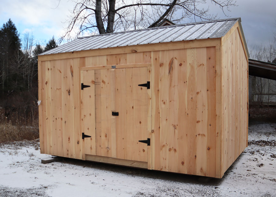A ten foot by fourteen foot wooden shed with double doors and a charcoal gray metal roof.