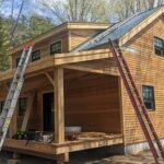 Vermont Cabin at the end stages of the building process with brown clapboard siding.